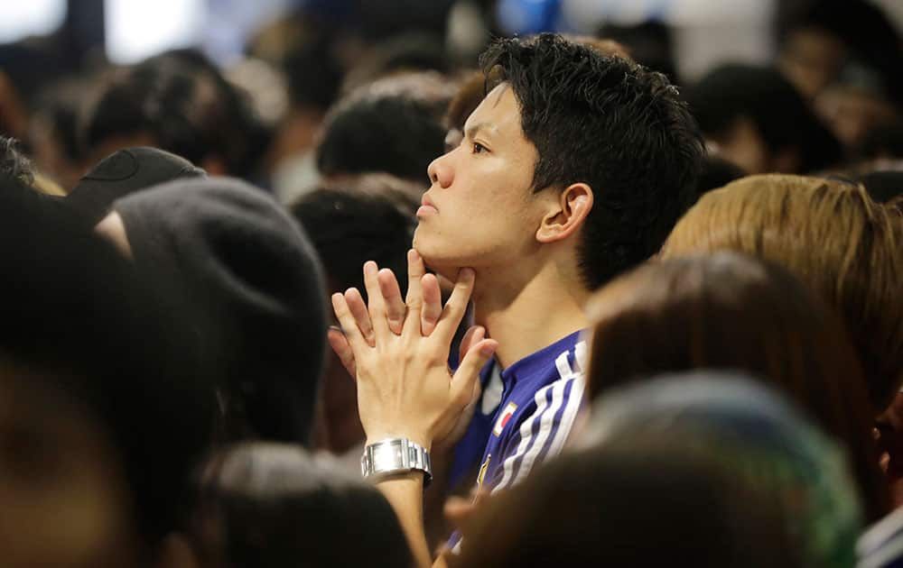 Japanese soccer fans are dejected during a live broadcast of the group C World Cup soccer match between Japan and Ivory Coast at a public viewing venue in Tokyo.