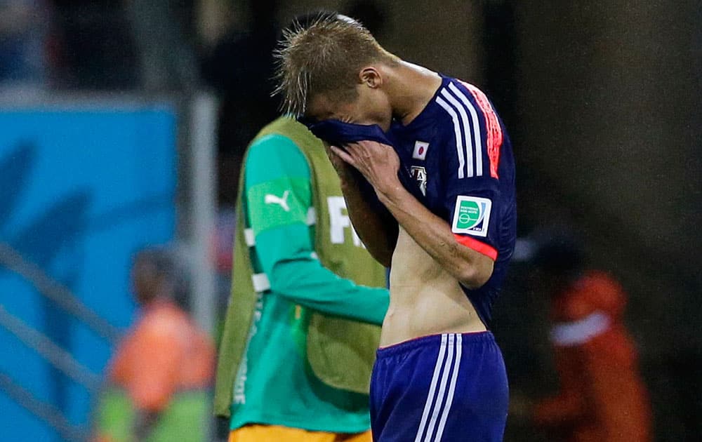 Japan's Keisuke Honda leaves the pitch after the group C World Cup soccer match between Ivory Coast and Japan at the Arena Pernambuco in Recife, Brazil.