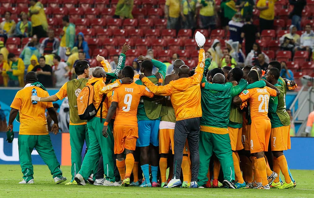 Ivory Coast players celebrate after the group C World Cup soccer match between Ivory Coast and Japan at the Arena Pernambuco in Recife, Brazil.