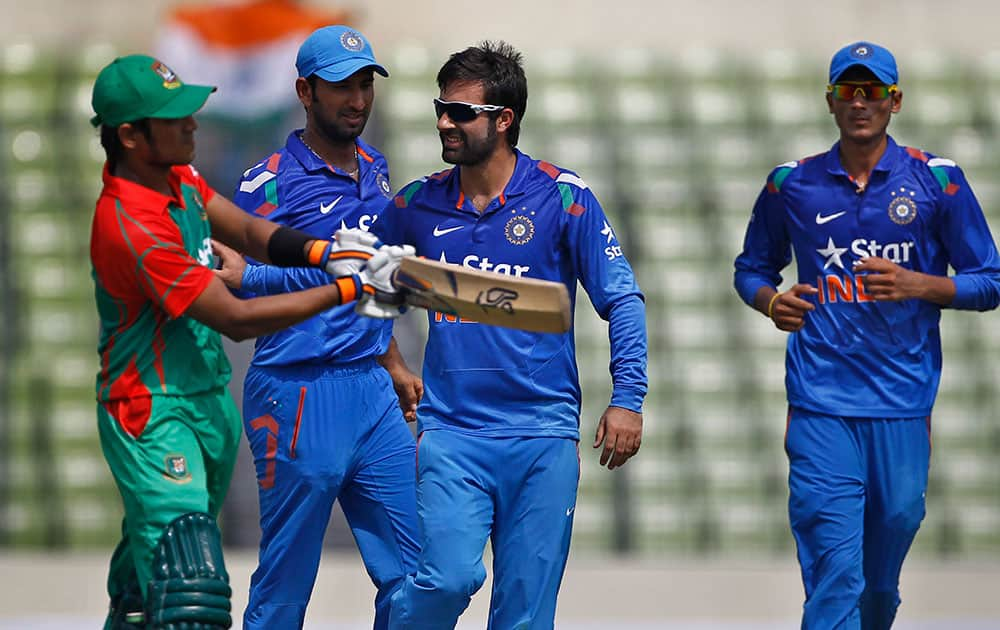 India's Parvez Rasool, second right, celebrates the wicket of Bangladesh’s Anamul Haque, left, during their first one-day International cricket match in Dhaka.