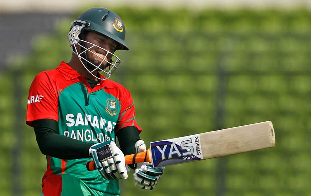 Bangladesh's Shakib Al Hasan reacts as he walks back to the pavilion after his dismissal by India's captain Suresh Raina during their first one-day International cricket match in Dhaka.