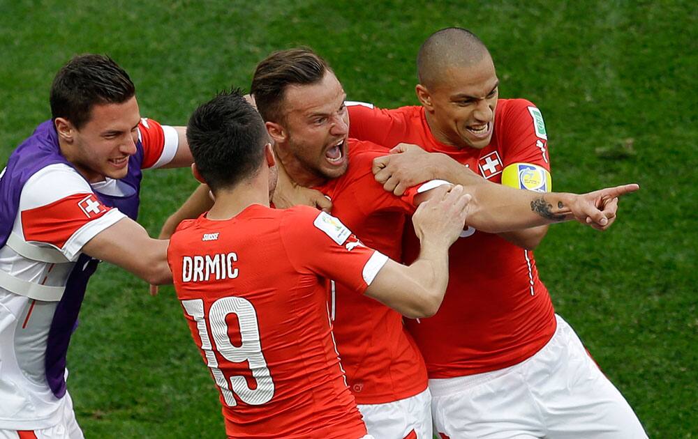 Switzerland's Haris Seferovic, second from right, celebrates scoring his side's second goal with teammates during the group E World Cup soccer match between Switzerland and Ecuador at the Estadio Nacional in Brasilia, Brazil.