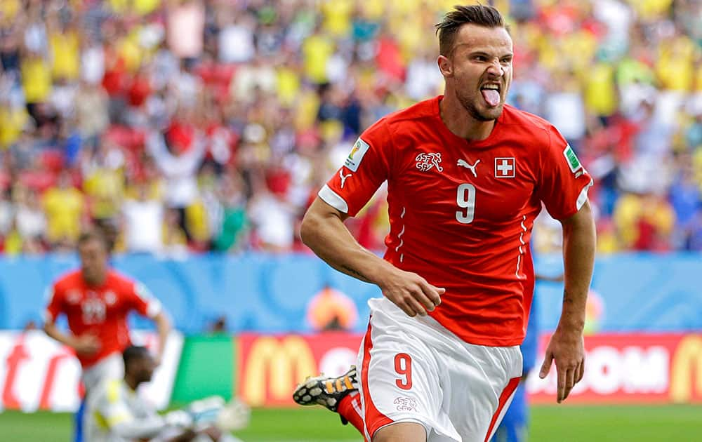 Switzerland's Haris Seferovic scores his side's second goal during the group E World Cup soccer match between Switzerland and Ecuador at the Estadio Nacional in Brasilia, Brazil.