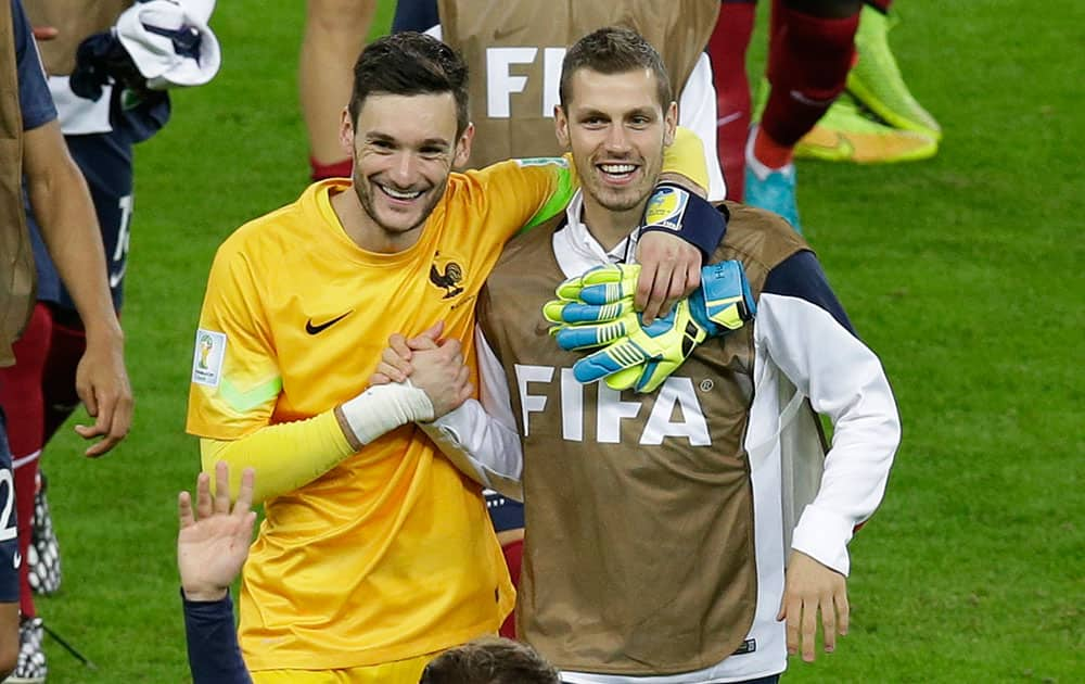 France's goalkeeper Hugo Lloris, left, and Clement Grenier smile after winning the group E World Cup soccer match between France and Honduras at the Estadio Beira-Rio in Porto Alegre, Brazil.