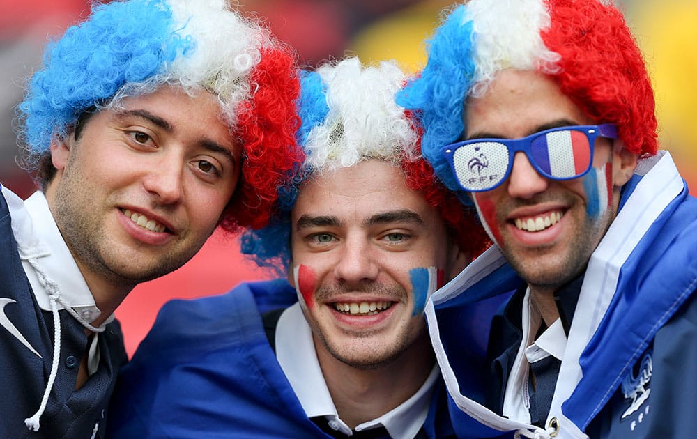 French supporters pose for a photo before the group E World Cup soccer match between France and Honduras at the Estadio Beira-Rio in Porto Alegre, Brazil.