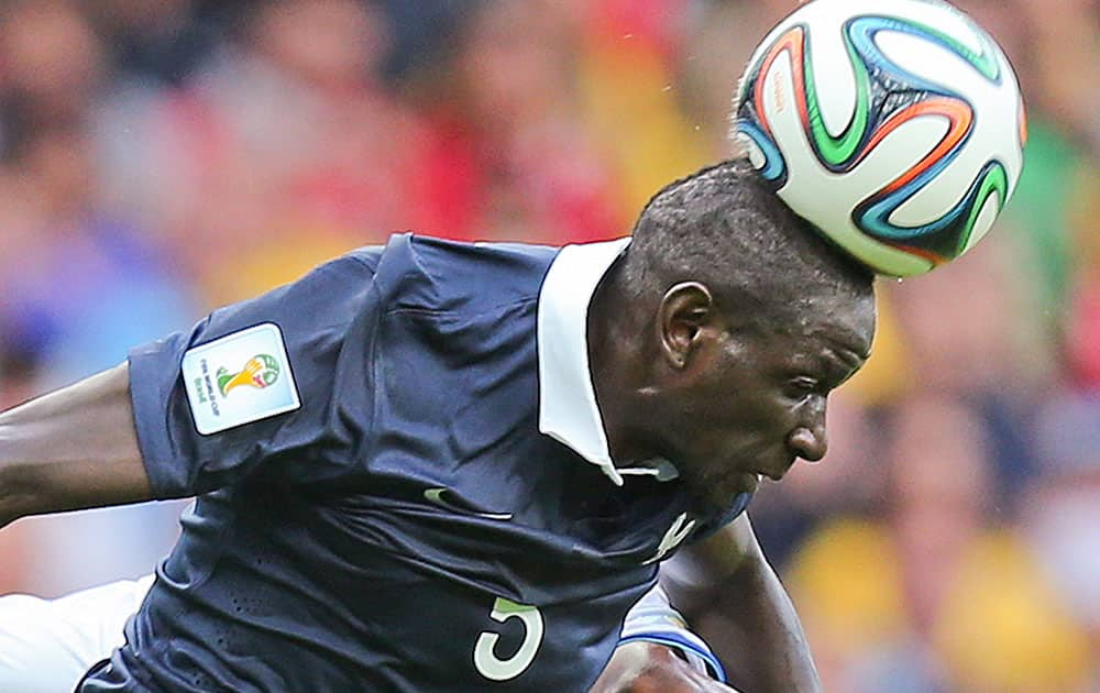 France's Mamadou Sakho heads the ball during the group E World Cup soccer match between France and Honduras at the Estadio Beira-Rio in Porto Alegre, Brazil.