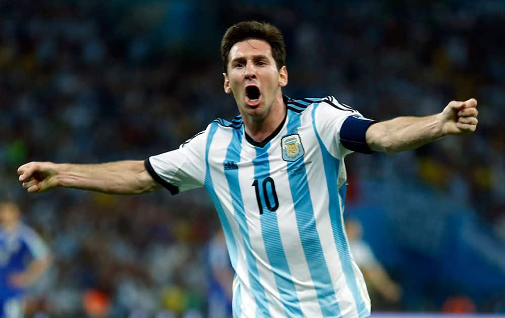 Argentina's Lionel Messi, centre, celebrates scoring his side's second goal during the group F World Cup soccer match between Argentina and Bosnia at the Maracana Stadium in Rio de Janeiro, Brazil.