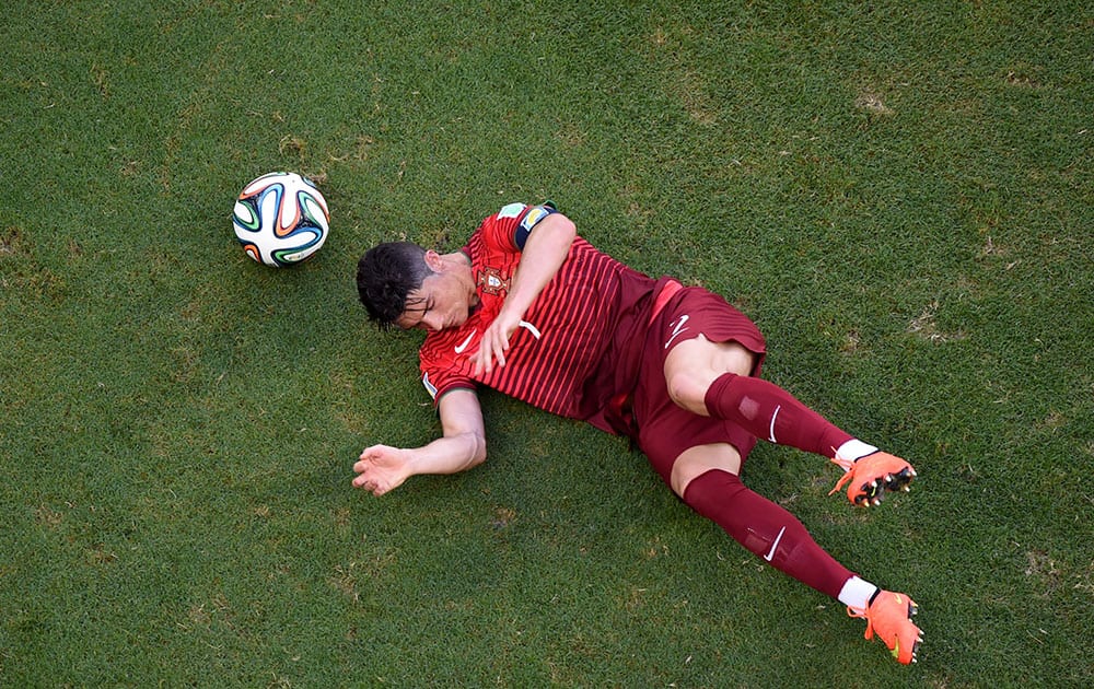 Portugal's Cristiano Ronaldo sits on the pitch during the group G World Cup soccer match between Germany and Portugal at the Arena Fonte Nova in Salvador, Brazil.