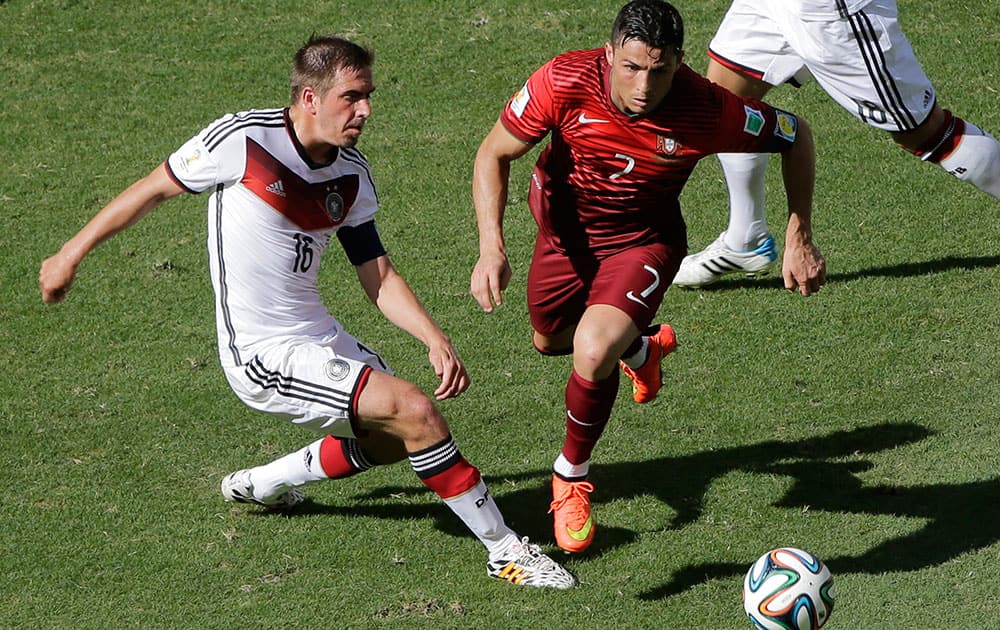 Portugal's Cristiano Ronaldo and Germany's Philipp Lahm go for the ball during the group G World Cup soccer match between Germany and Portugal at the Arena Fonte Nova in Salvador, Brazil.