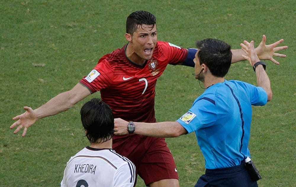 Portugal's Cristiano Ronaldo protests to referee Milorad Mazic from Serbia during the group G World Cup soccer match between Germany and Portugal at the Arena Fonte Nova in Salvador, Brazil.