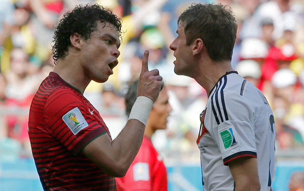 Portugal's Pepe, left, argues with Germany's Thomas Mueller after they clashed during the group G World Cup soccer match between Germany and Portugal at the Arena Fonte Nova in Salvador, Brazil.