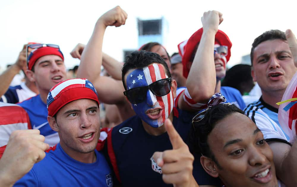 Americans soccer fans pose for the picture during a live broadcast of the soccer World Cup match between Iran and Nigeria, inside the FIFA Fan Fest area on Copacabana beach, Rio de Janeiro, Brazil.