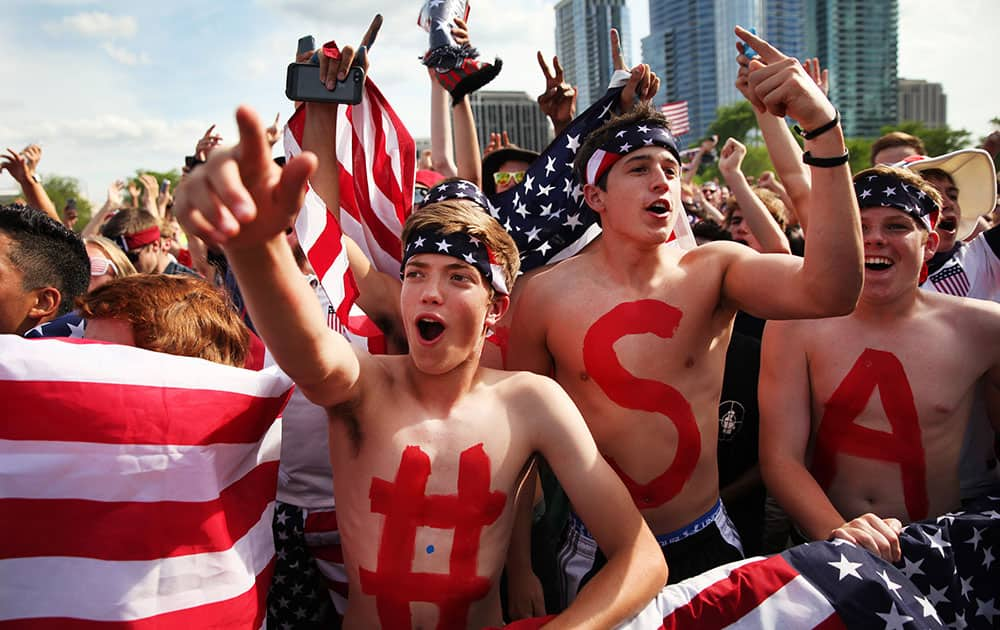 Brad Hickman, 16, left, and Barrett Shutt, 18, cheer for the US Men's National Team at a World Cup viewing party at Grant Park.