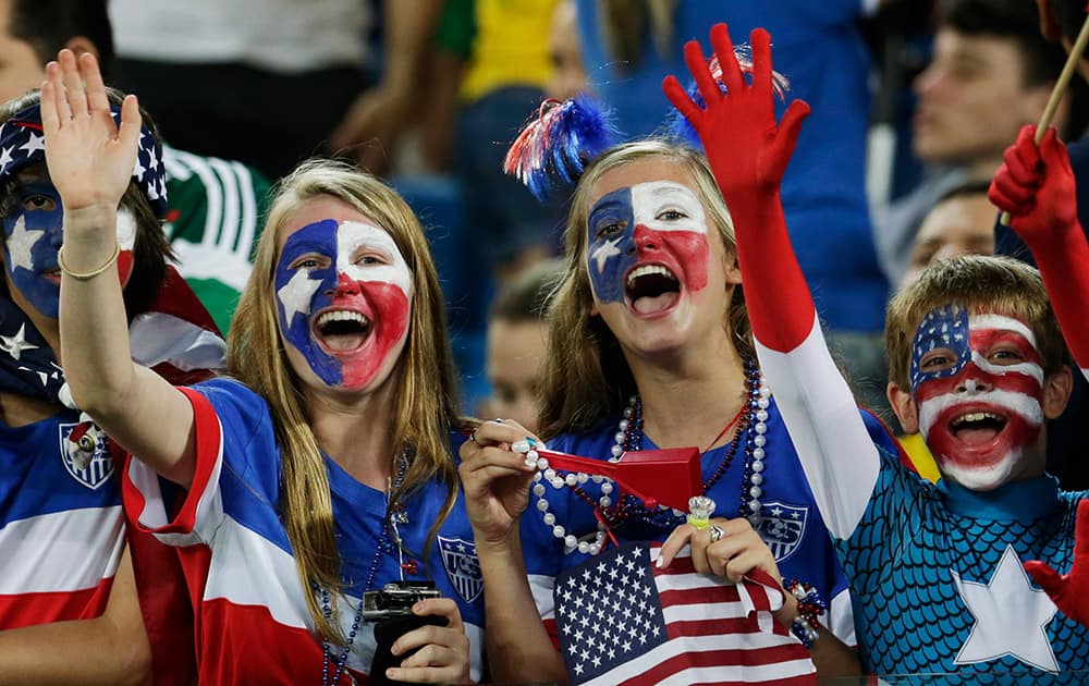 American fans cheer for their team before the group G World Cup soccer match between Ghana and the United States at the Arena das Dunas in Natal, Brazil.