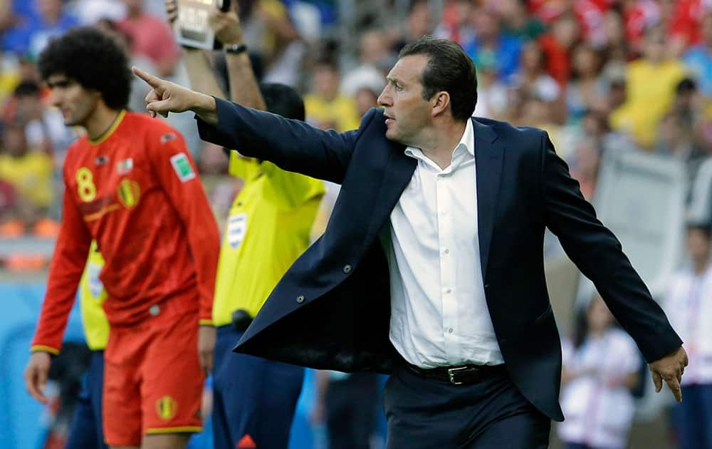 Belgium's head coach Marc Wilmots gestures as he prepares to introduce Belgium's Marouane Fellaini to the match during the group H World Cup soccer match between Belgium and Algeria at the Mineirao Stadium in Belo Horizonte, Brazil.