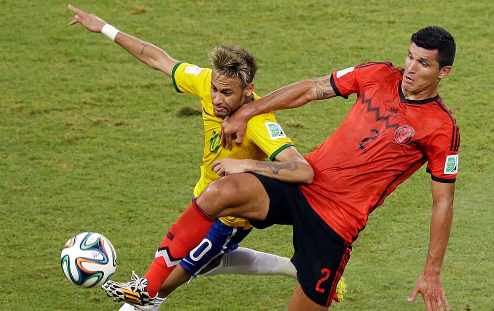 Brazil's Neymar, left, and Mexico's Francisco Rodriguez challenge for the ball during the group A World Cup soccer match between Brazil and Mexico at the Arena Castelao in Fortaleza, Brazil.