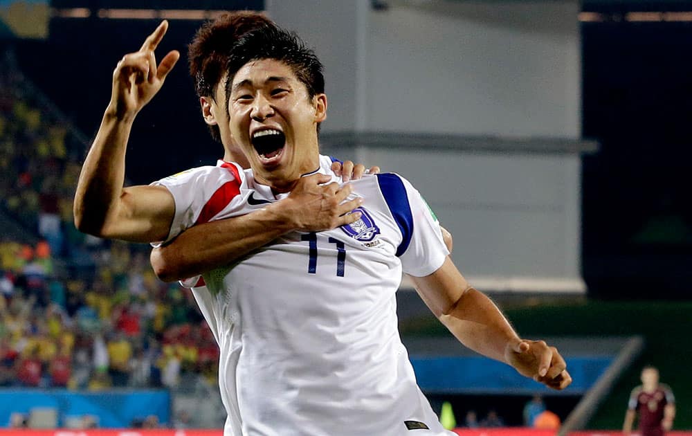 South Korea's Lee Keun-ho, celebrates after scoring the opening goal during the group H World Cup soccer match between Russia and South Korea at the Arena Pantanal in Cuiaba, Brazil.