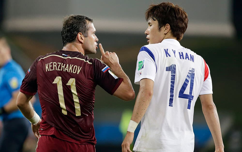 Russia's Alexander Kerzhakov, left, gives a quiet sign to South Korea's Han Kook-young during the group H World Cup soccer match between Russia and South Korea at the Arena Pantanal in Cuiaba, Brazil.