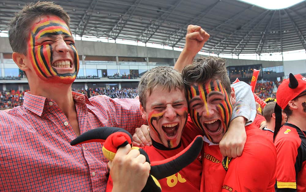 Fans of the Belgian national soccer team cheer during the match against Algeria, broadcast live on a giant video screen at the Ghelamco soccer stadium in Ghent, western Belgium.