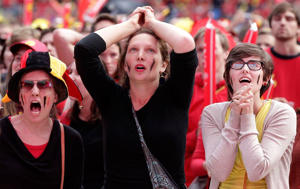 Fans of the Belgian national soccer team watch the match against Algeria, broadcast live on a giant video screen at the Ghelamco soccer stadium in Ghent, western Belgium.