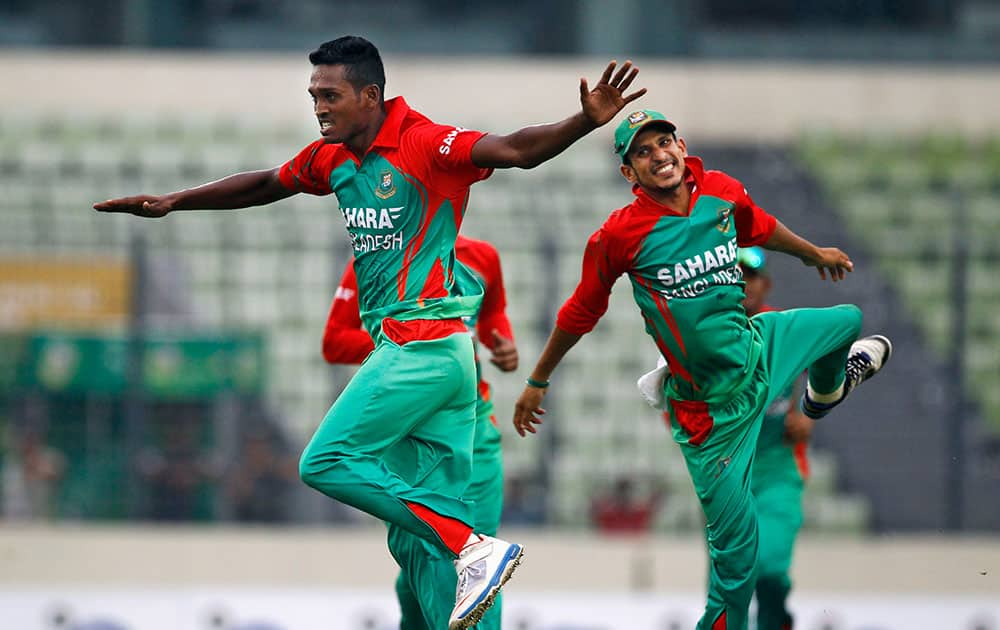 Bangladesh's Al-Amin Hossain, left, celebrates with teammate Nasir Hossain the dismissal of India's Akshar Patel during their second one-day International cricket match in Dhaka, Bangladesh.