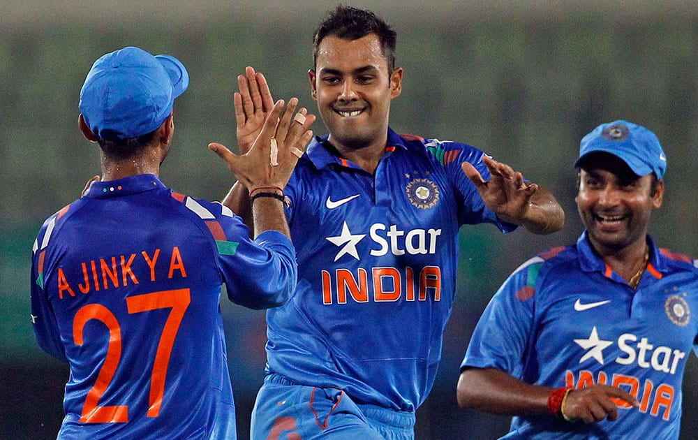 India's Stuart Binny, center, celebrates with teammates after the wicket of Bangladesh's Mahmudullah during their second one-day International cricket match in Dhaka, Bangladesh.