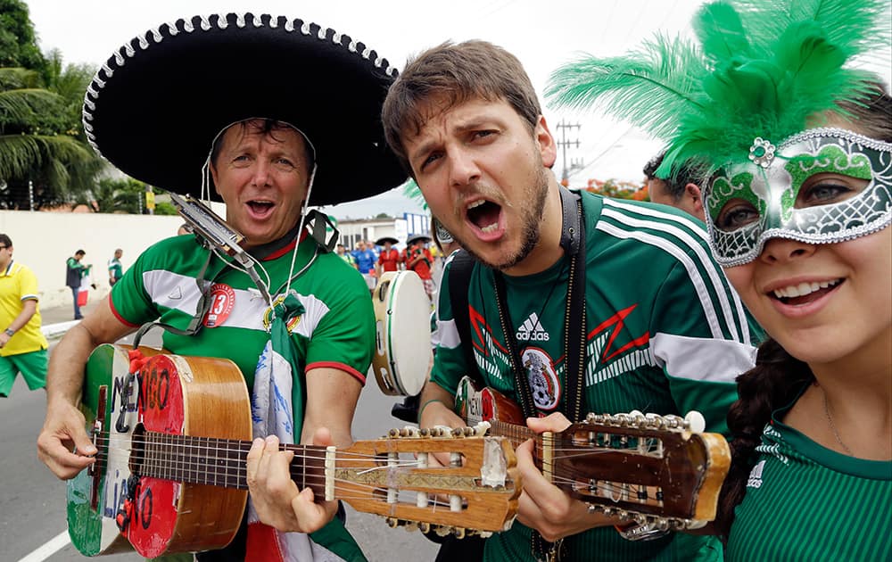 Mexico fans play guitar prior to the group A World Cup soccer match between Brazil and Mexico at the Arena Castelao in Fortaleza, Brazil.