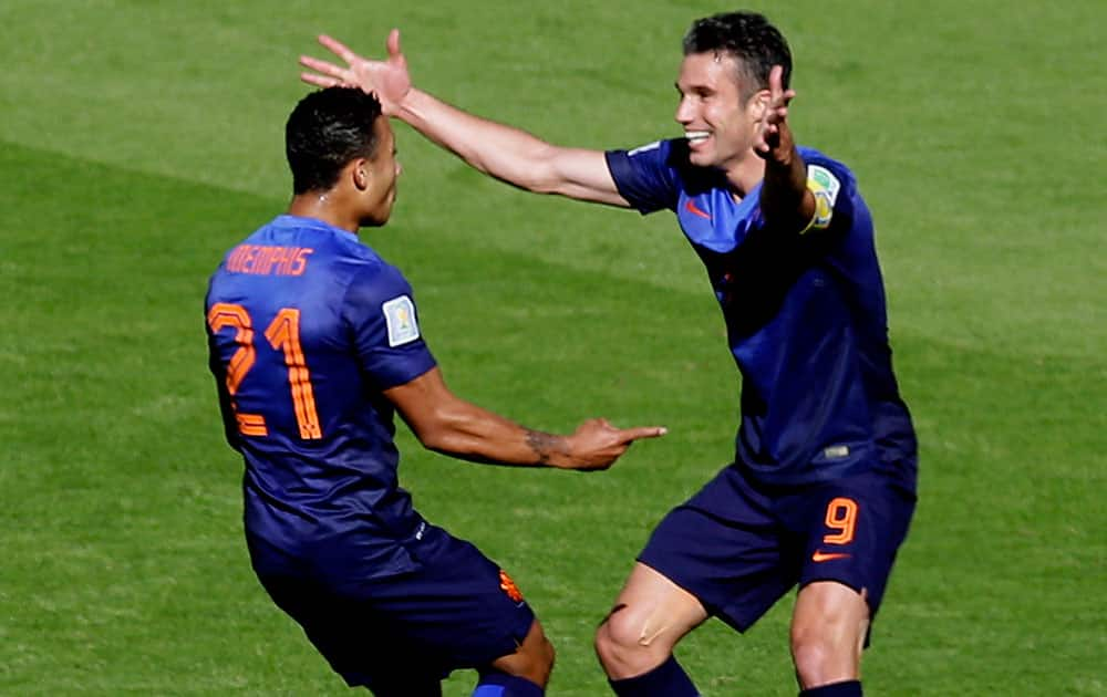 Netherlands' Memphis Depay, left, celebrates with Robin van Persie after scoring his side's 3rd goal during the group B World Cup soccer match between Australia and the Netherlands at the Estadio Beira-Rio in Porto Alegre, Brazil.