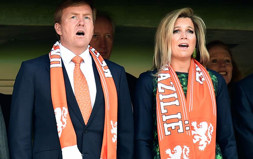 Dutch King Willem-Alexanderd and his wife Queen Maxima sing the national anthem before the start of the group B World Cup soccer match between Australia and the Netherlands at the Estadio Beira-Rio in Porto Alegre, Brazil.