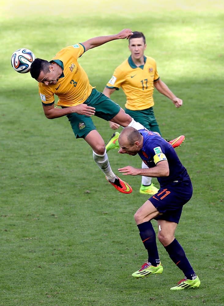 Australia's Matt McKay, right, looks on as Australia's Jason Davidson, left, and Netherlands' Arjen Robben challenge for the ball during the group B World Cup soccer match between Australia and the Netherlands at the Estadio Beira-Rio in Porto Alegre, Brazil.