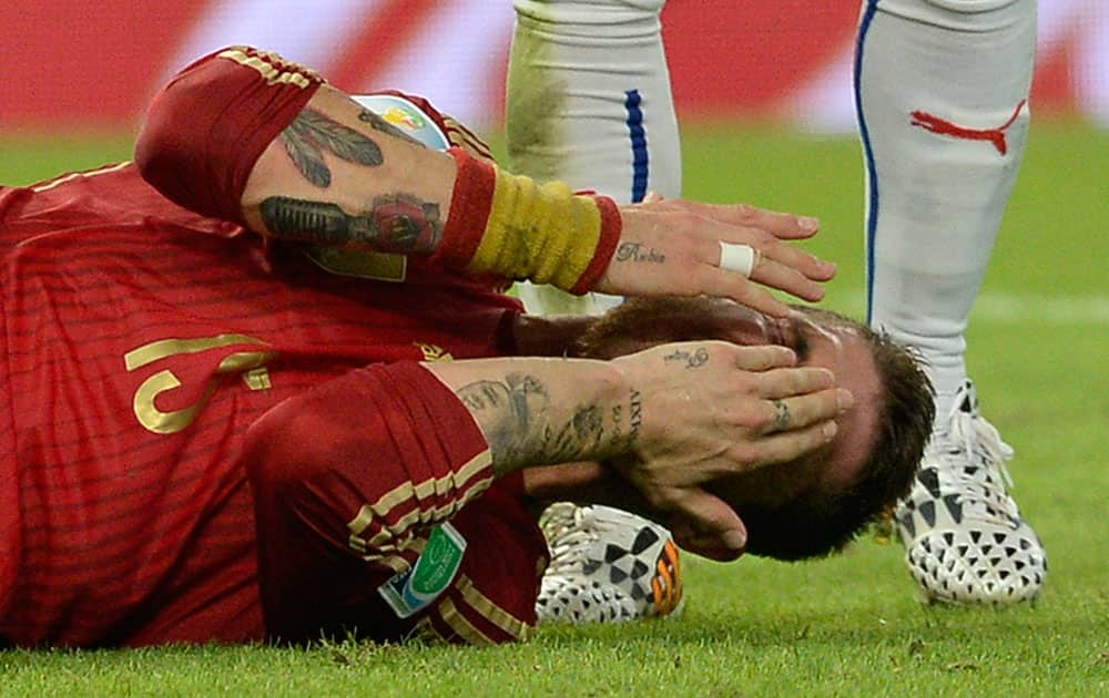 Spain's Sergio Ramos reacts after taking a kick to the face during the group B World Cup soccer match between Spain and Chile at the Maracana Stadium in Rio de Janeiro, Brazil.