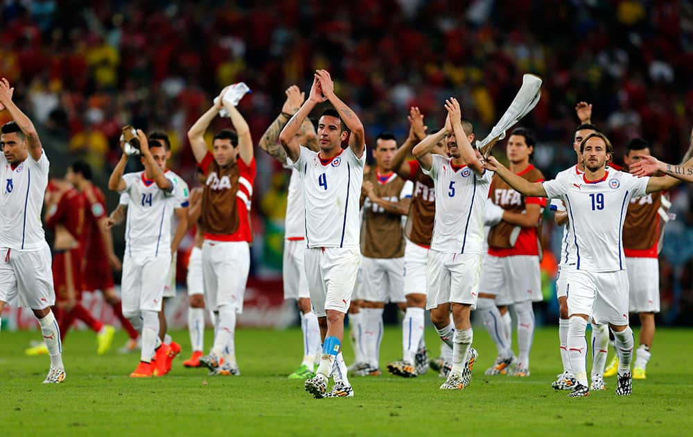 Chile's national team applaud spectators after their victory over Spain during the group B World Cup soccer match between Spain and Chile at the Maracana Stadium in Rio de Janeiro, Brazil.