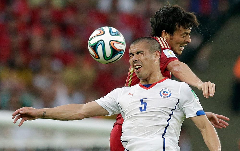 Chile's Francisco Silva is challenged by Spain's David Silva during the group B World Cup soccer match between Spain and Chile at the Maracana Stadium in Rio de Janeiro, Brazil.