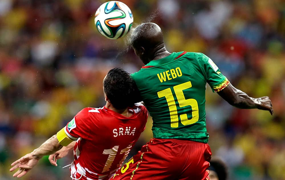 Cameroon's Pierre Webo, right, and Croatia's Darijo Srna battle for the ball during the group A World Cup soccer match between Cameroon and Croatia at the Arena da Amazonia in Manaus, Brazil.