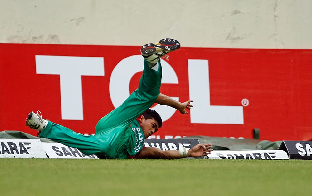 Bangladesh's Taskin Ahmed dives to stop a shot while fielding during the third one-day International cricket match against India in Dhaka.