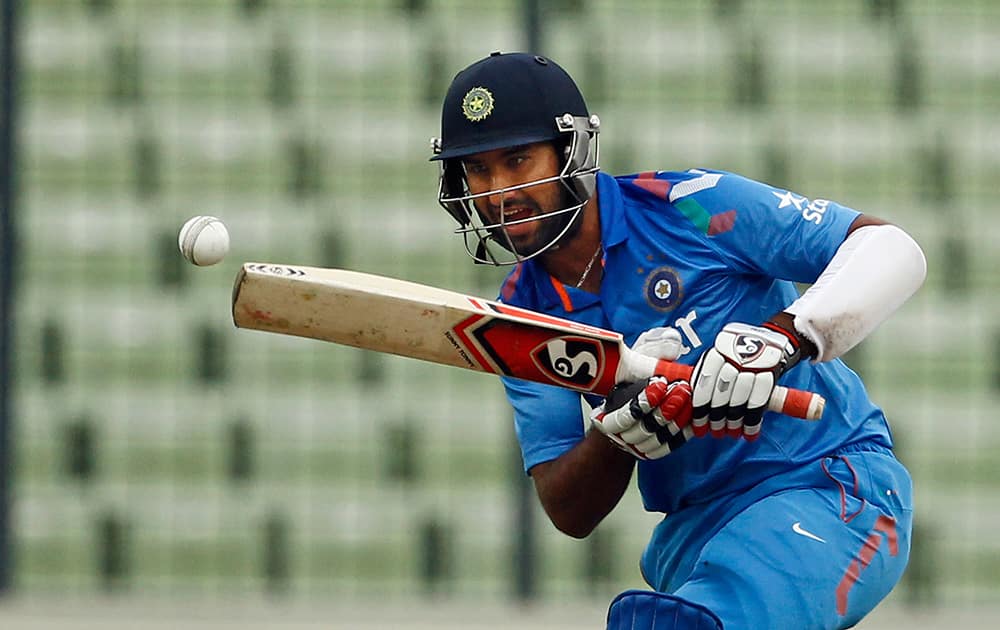 Cheteshwar Pujara plays a shot during the third one-day International cricket match against Bangladesh in Dhaka, Bangladesh.