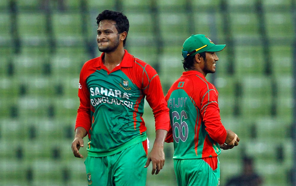 Bangladesh's Shakib Al Hasan, left, reacts after delivering a ball as Anamul Haque smiles during their third one-day International cricket match against India in Dhaka