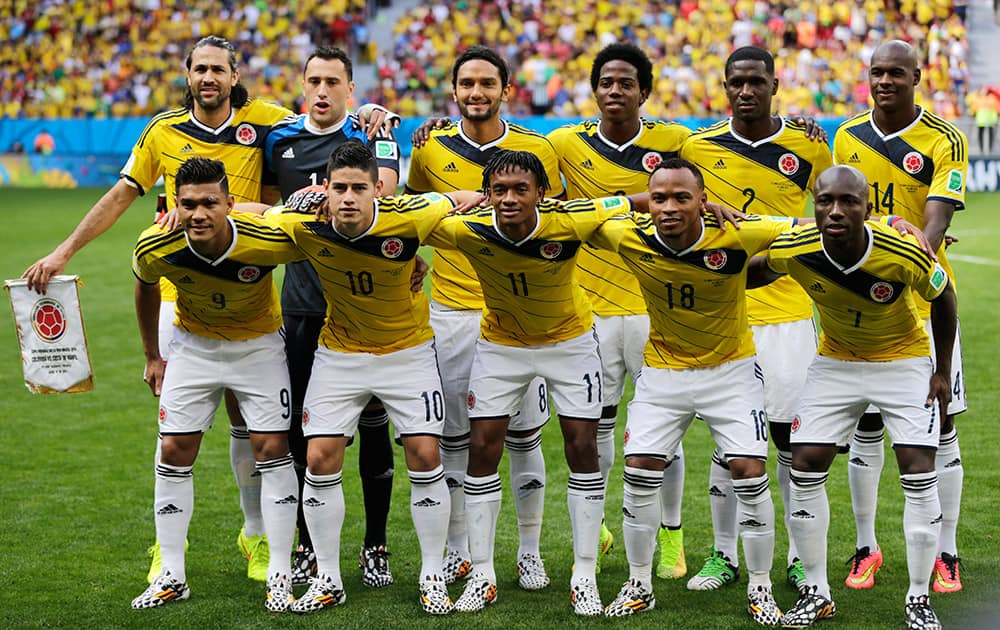 The Columbian national team poses for a photo before the group C World Cup soccer match between Colombia and Ivory Coast at the Estadio Nacional in Brasilia.