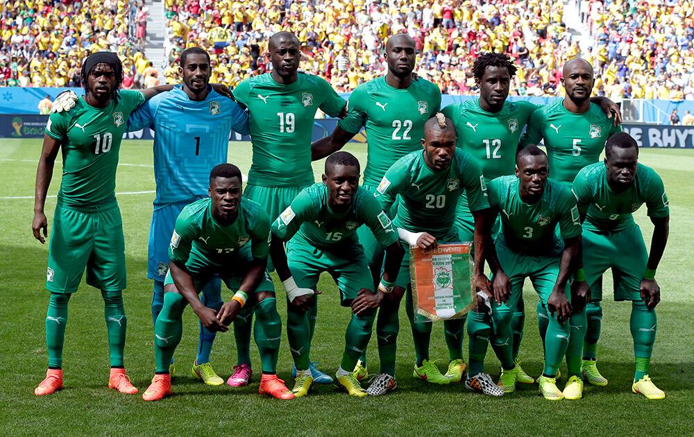 The Ivory Coast team pose for a group photo before the group C World Cup soccer match between Colombia and Ivory Coast at the Estadio Nacional in Brasilia, Brazil.