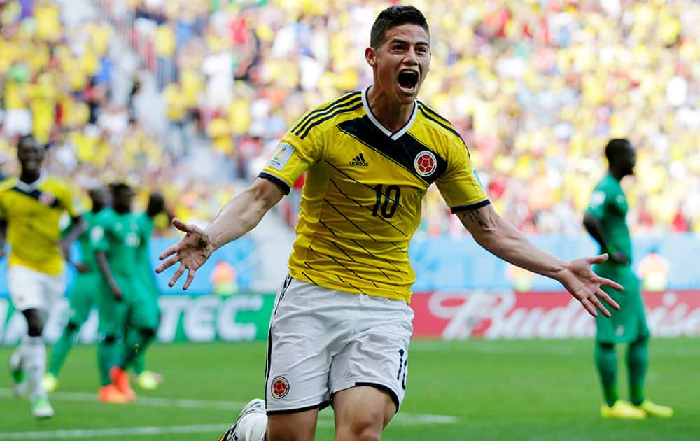 Colombia's James Rodriguez celebrates after scoring his side's first goal during the group C World Cup soccer match between Colombia and Ivory Coast at the Estadio Nacional in Brasilia.