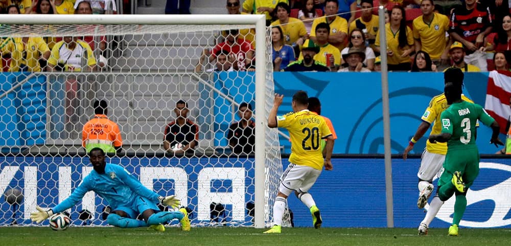 Colombia's Juan Quintero (20) scores his side's second goal during the group C World Cup soccer match between Colombia and Ivory Coast at the Estadio Nacional in Brasilia.