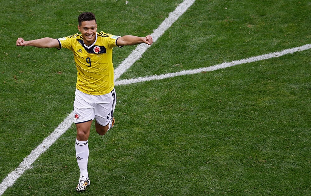 Colombia's Teofilo Gutierrez celebrates after scoring his team's second goal during the group C World Cup soccer match between Colombia and Ivory Coast at the Estadio Nacional in Brasilia, Brazil.