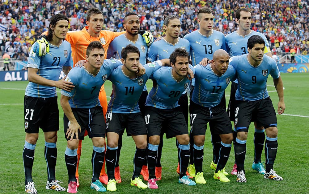 The Uruguay team pose for a group photo before the group D World Cup soccer match between Uruguay and England at the Itaquerao Stadium in Sao Paulo, Brazil