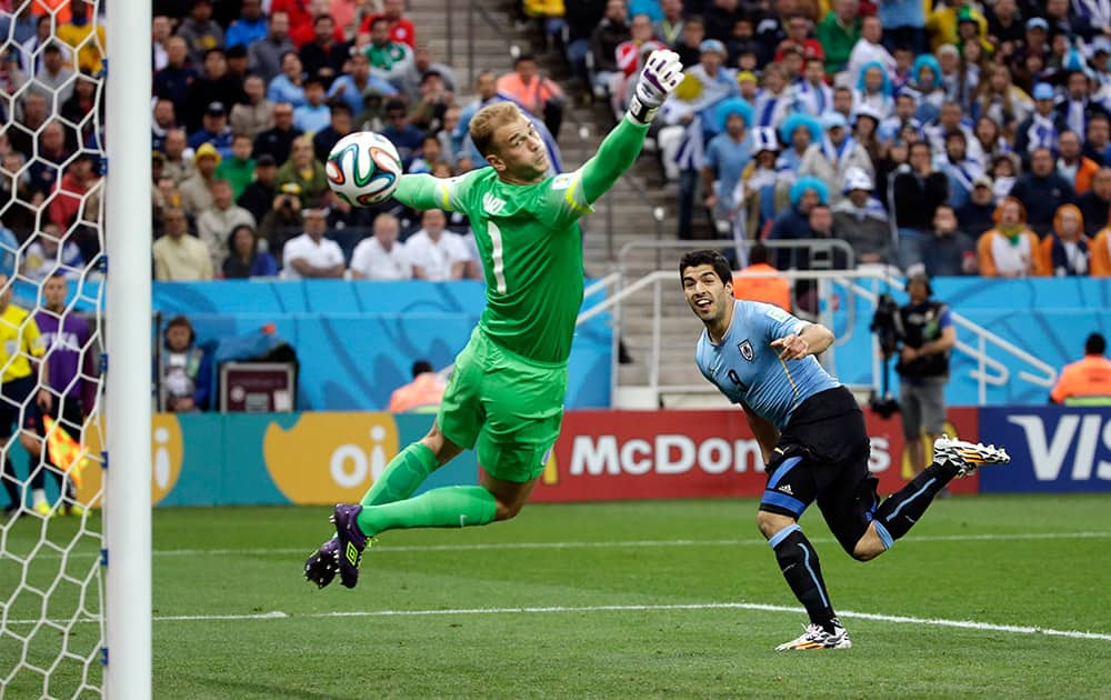 England's goalkeeper Joe Hart can't stop Uruguay's Luis Suarez's header to score his side's first goal during the group D World Cup soccer match between Uruguay and England at the Itaquerao Stadium in Sao Paulo.