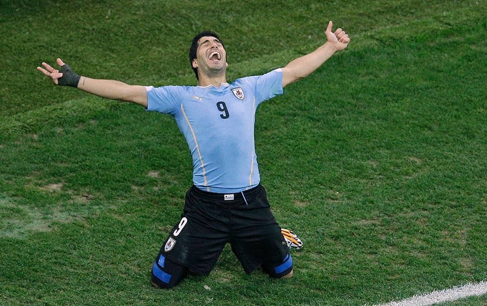 Uruguay's Luis Suarez celebrates scoring 2-1 during the group D World Cup soccer match between Uruguay and England at the Itaquerao Stadium in Sao Paulo.