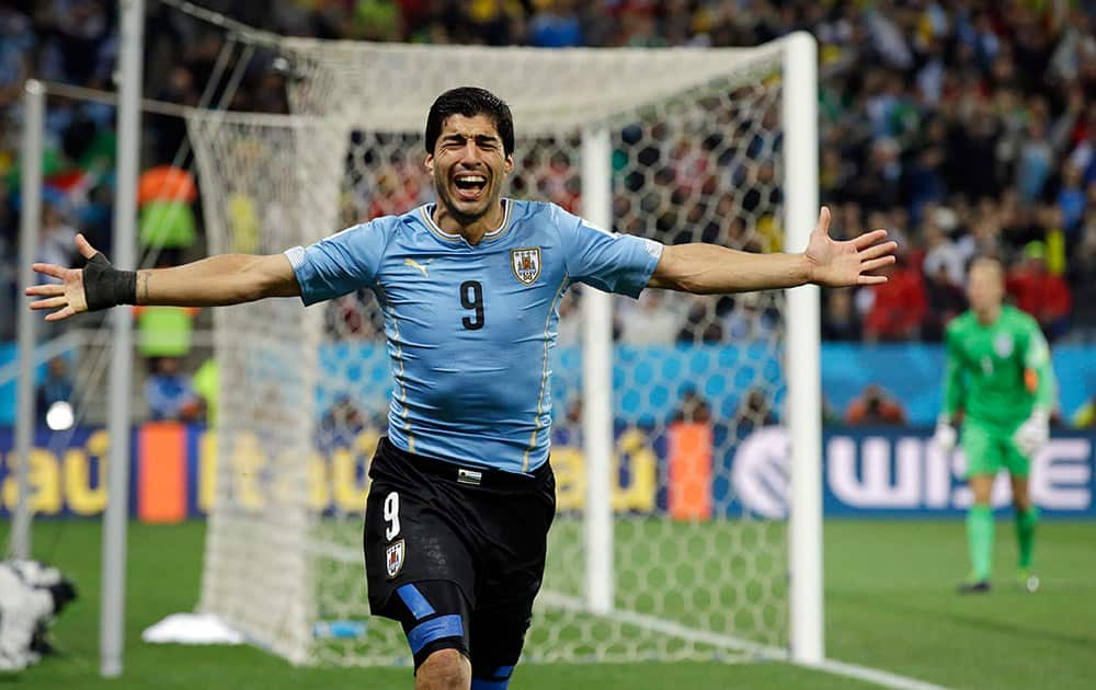 Uruguay's Luis Suarez celebrates after scoring his side's second goal during the group D World Cup soccer match between Uruguay and England at the Itaquerao Stadium in Sao Paulo.