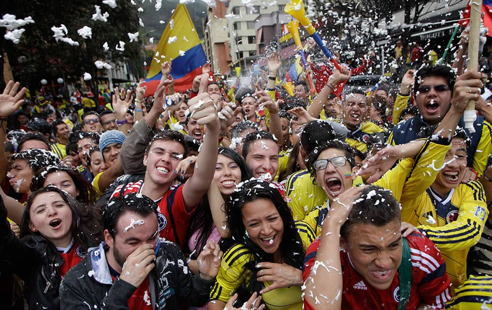 Colombia soccer fans cheer after their team's World Cup victory over Ivory Coast in Bogota, Colombia.