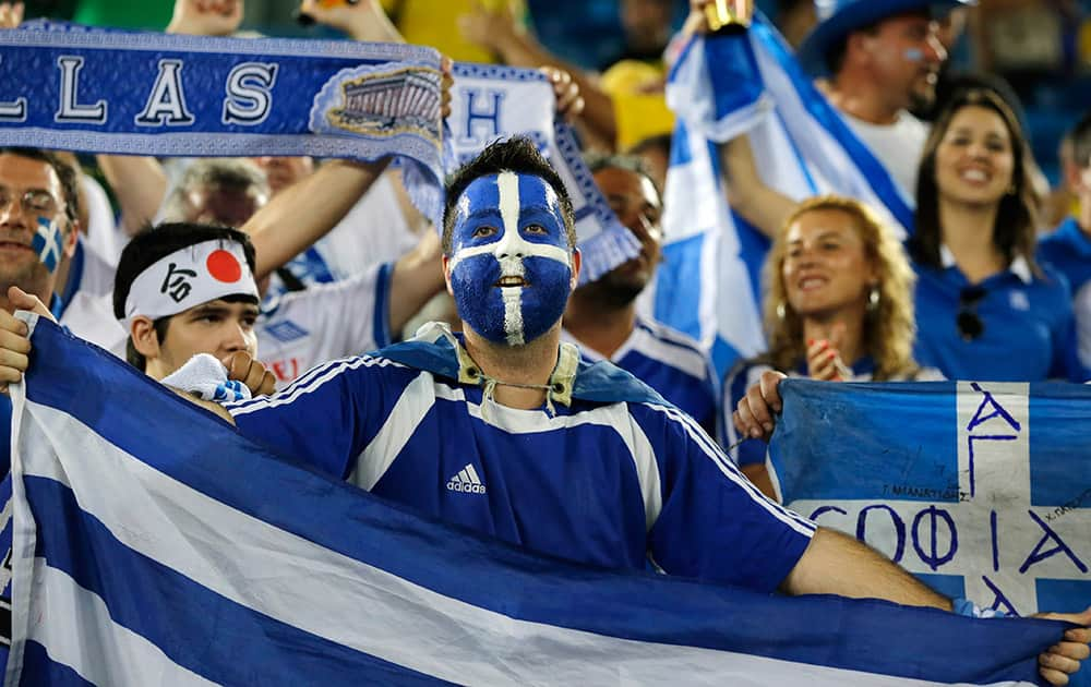 Greek fans wait for the start of the group C World Cup soccer match between Japan and Greece at the Arena das Dunas in Natal, Brazil.