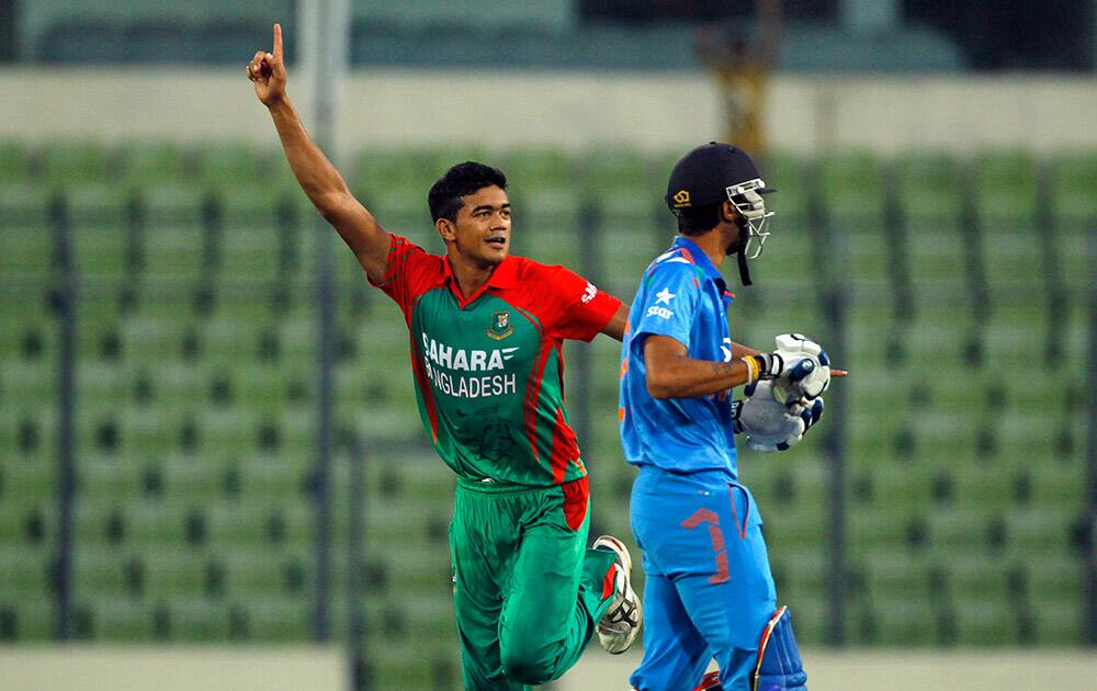 Bangladesh's Taskin Ahmed, left, celebrates the dismissal of India's Akshar Patel, right, during their third one-day International cricket match in Dhaka.