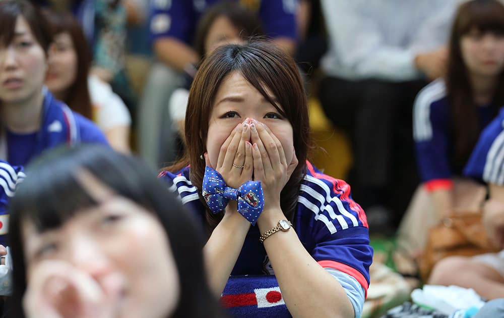 Japanese soccer fans watch a live broadcast of the Group C World Cup soccer match between Japan and Greece at a public viewing venue set up at Marunouchi business district in Tokyo.